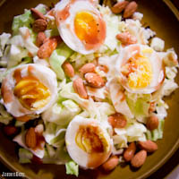 Warm cabbage salad with egg, almond, and pomegranate vinaigrette